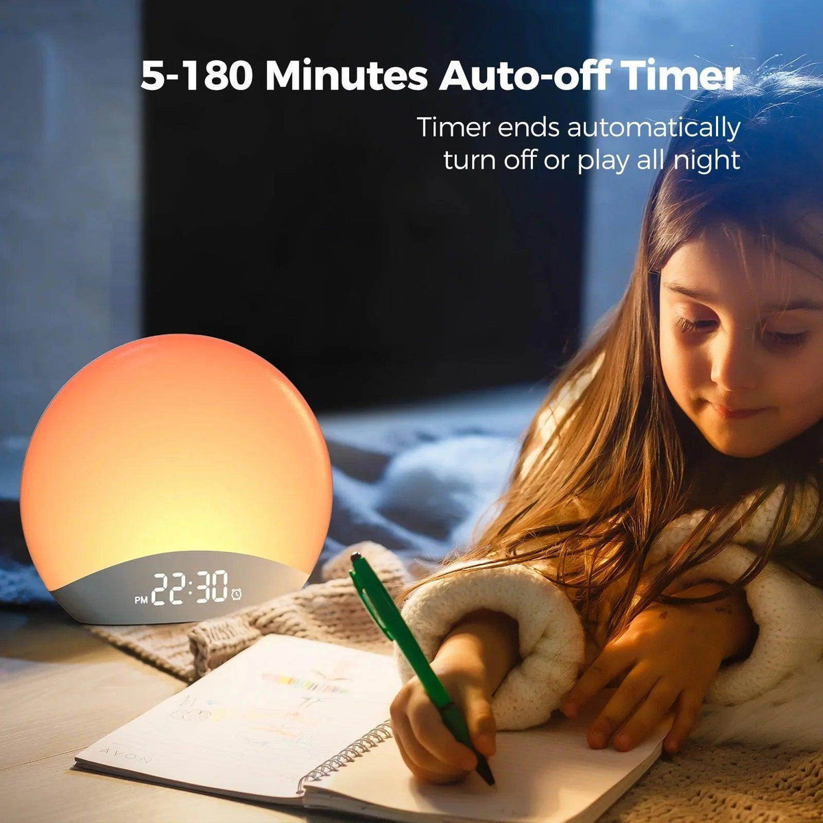 Sunrise alarm clock with orange light glow and digital clock on base