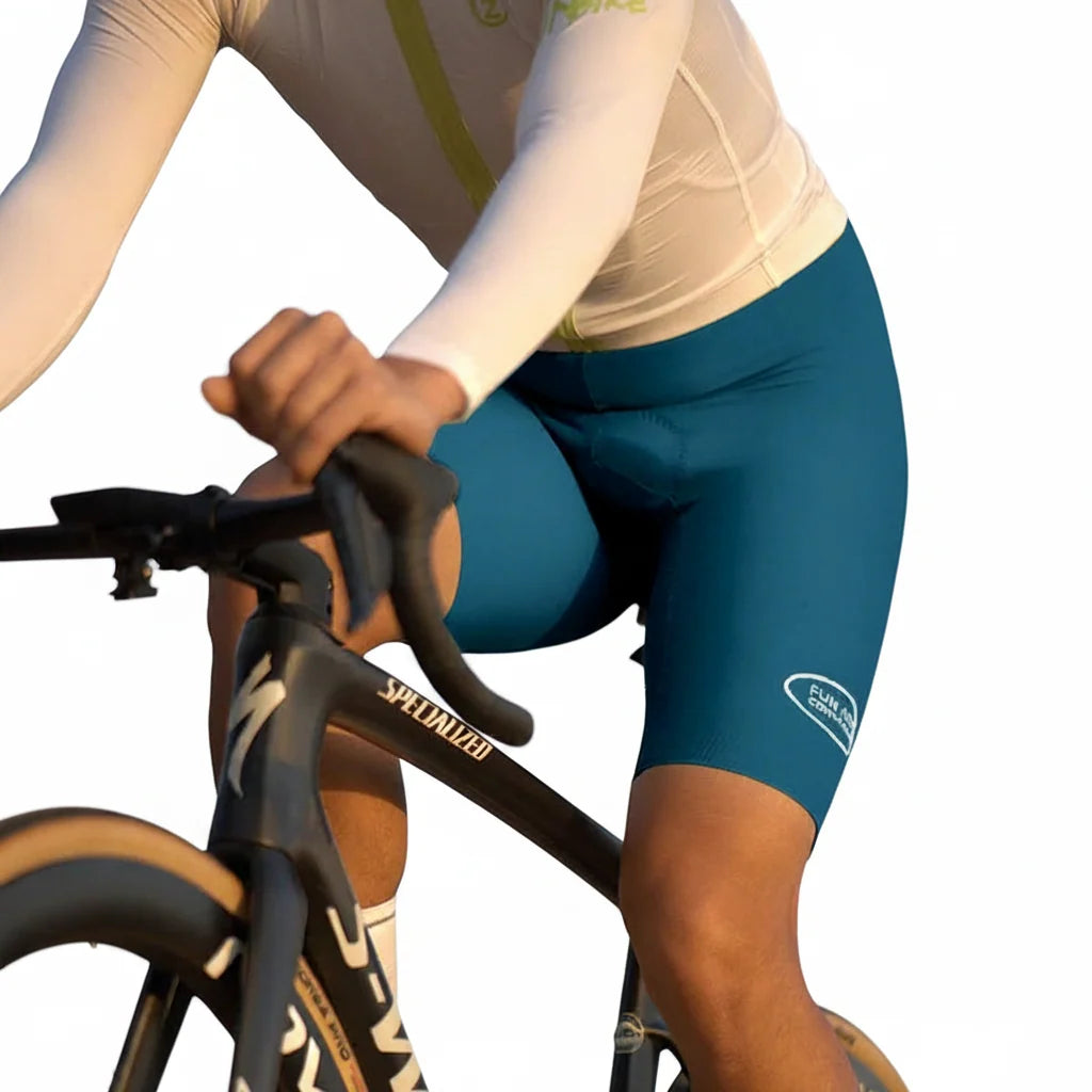 Men's padded cycling shorts in dark teal with side logo patch