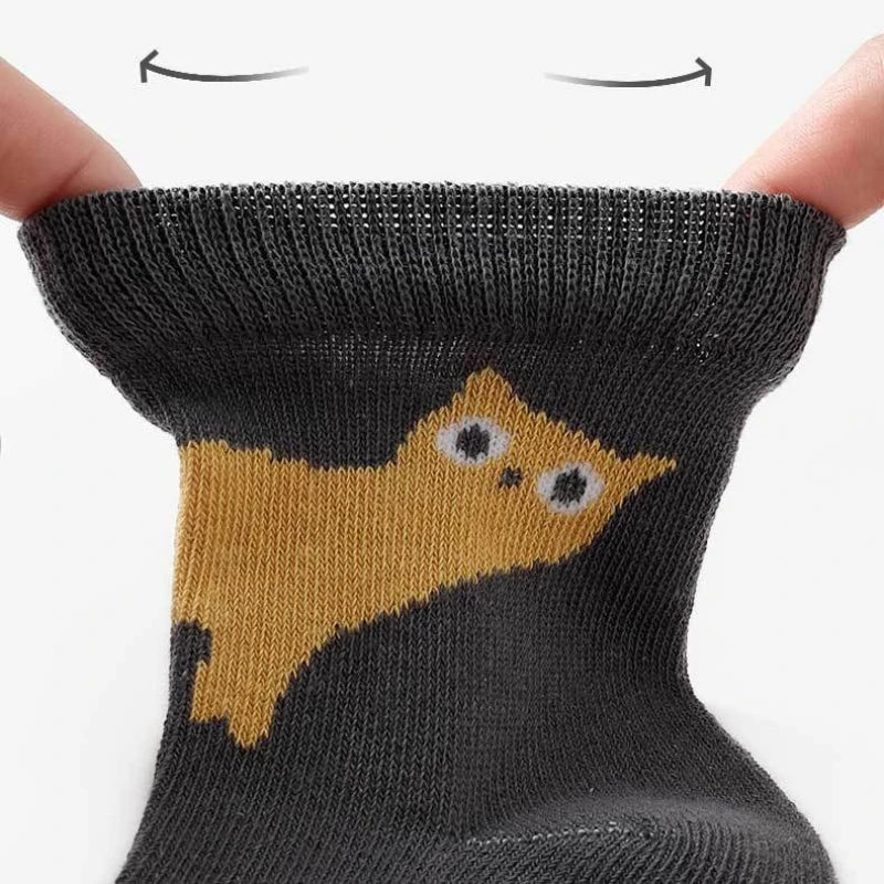 Kids cartoon cat crew socks, dark sock with yellow cat graphic on foot