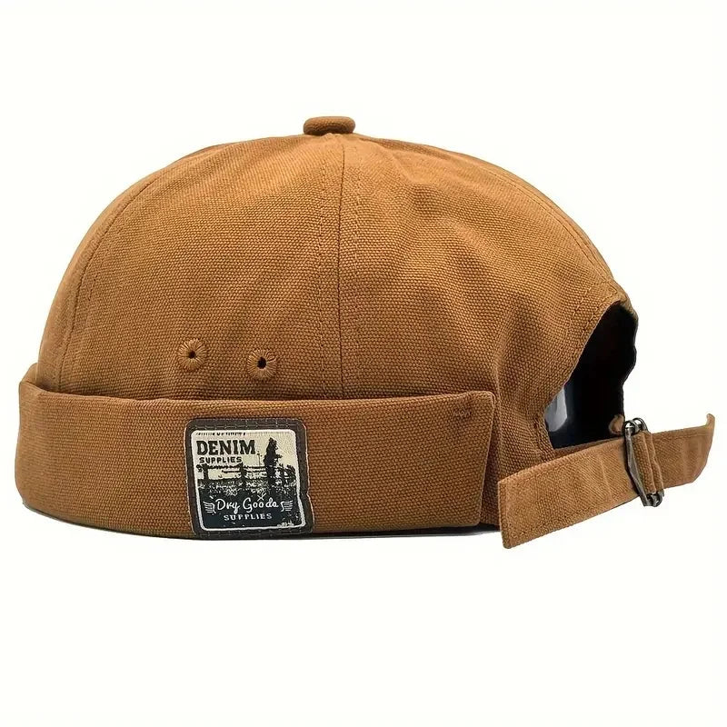 Tan/brown dome cap with denim logo patch and side strap with metal buckle
