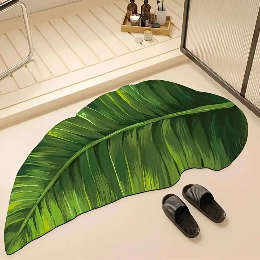 Green leaf-shaped bath mat rug with detailed veining and curved tip