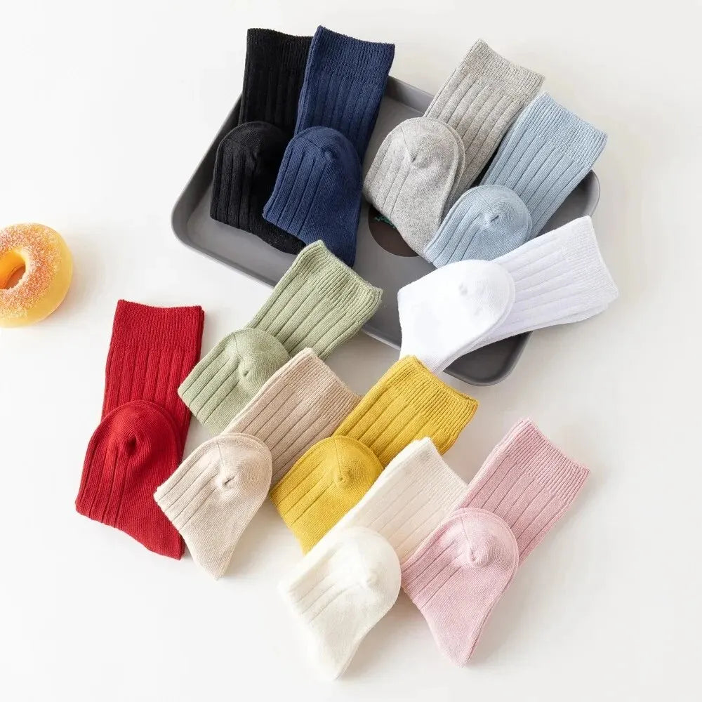 Kids knee-high striped socks in black, navy, gray, light blue, green, red, cream, and yellow.
