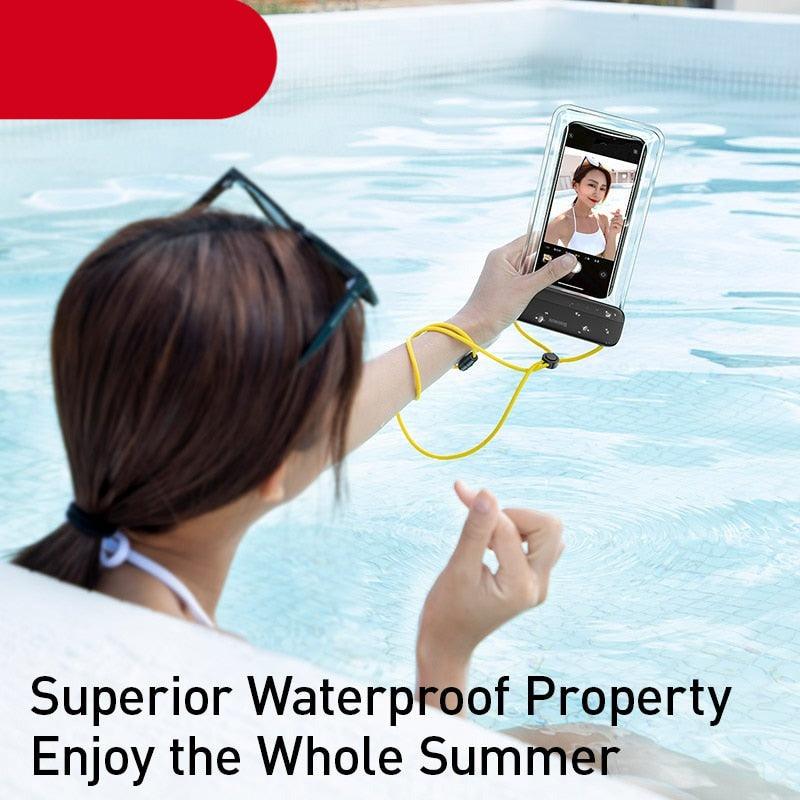 Transparent waterproof phone pouch with lanyard held up at water