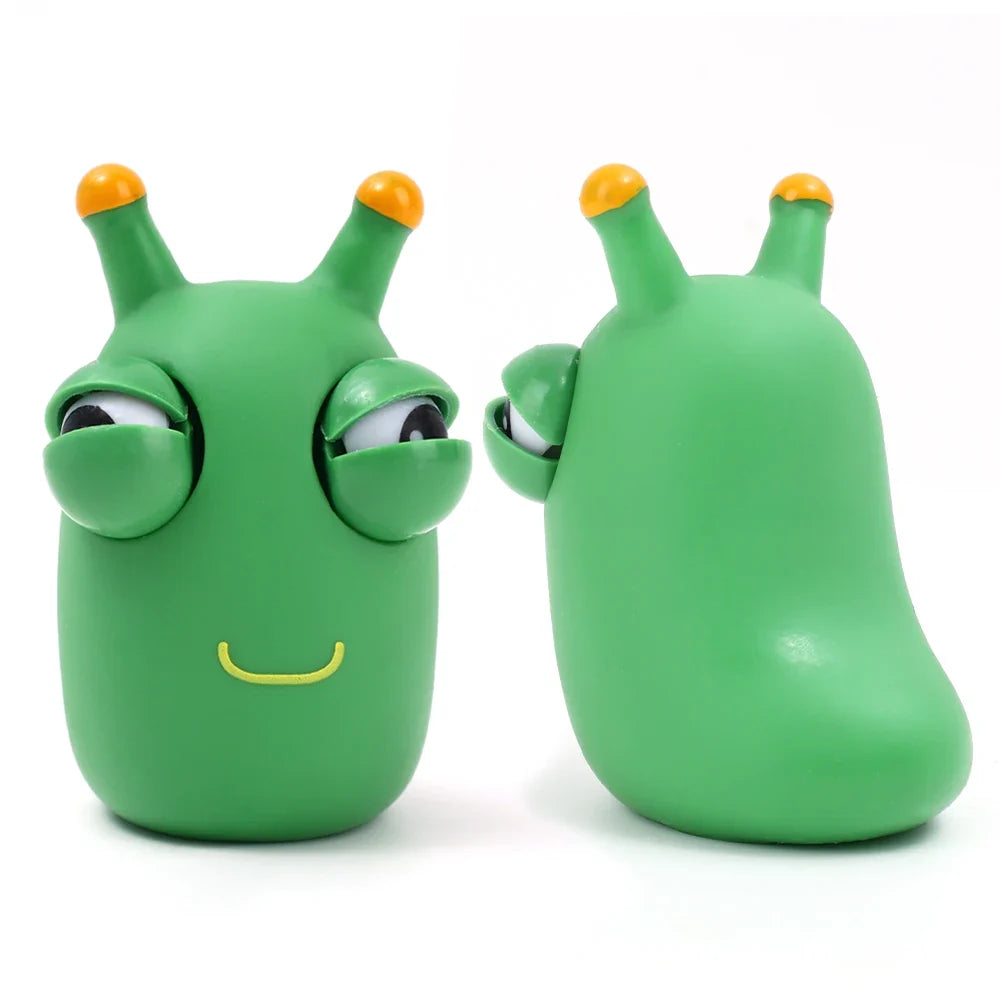 Green worm squeeze fidget toy showing front and back views with pop-out eyes