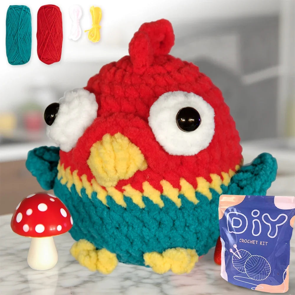 Crochet monster toy plush with large red body, teal wings, and big white eye