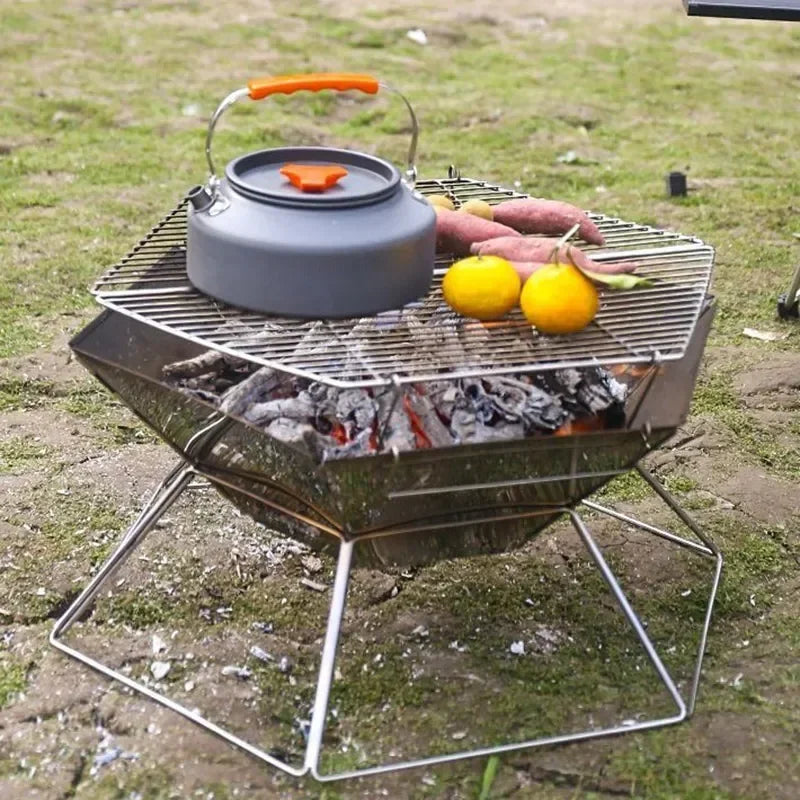 Folding outdoor fire grill with grate, kettle on top, and glowing charcoal