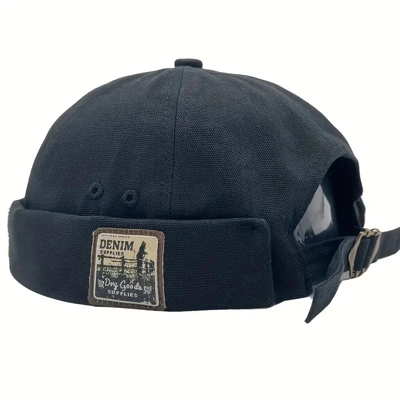 Navy dome cap with denim logo patch and side strap with metal buckle