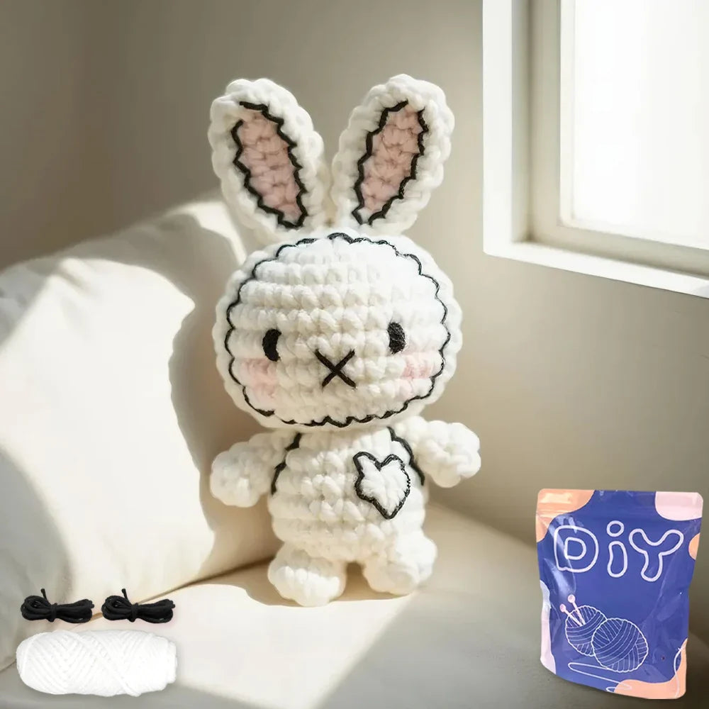 White crocheted bunny plush with pink inner ears and a heart nose with kit pouch