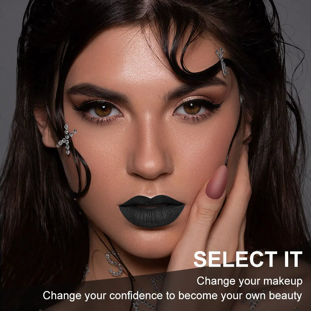 Matte black lipstick on lips with dark eye makeup and face jewelry