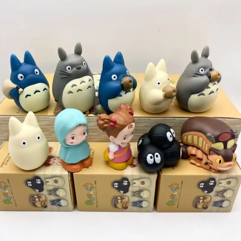 Collection of cartoon blind box figurines lined up on desk trays, with blue and cream faces