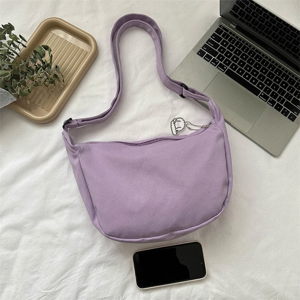 Lavender crossbody bag with puppy pendant and adjustable strap, zip-top