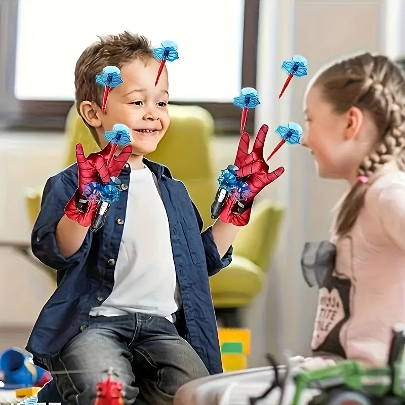 Spider wrist launcher accessories worn by child: red gloves with blue web shooters