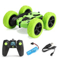 Lime green RC stunt car with oversized tread wheels and black 2.4G remote control