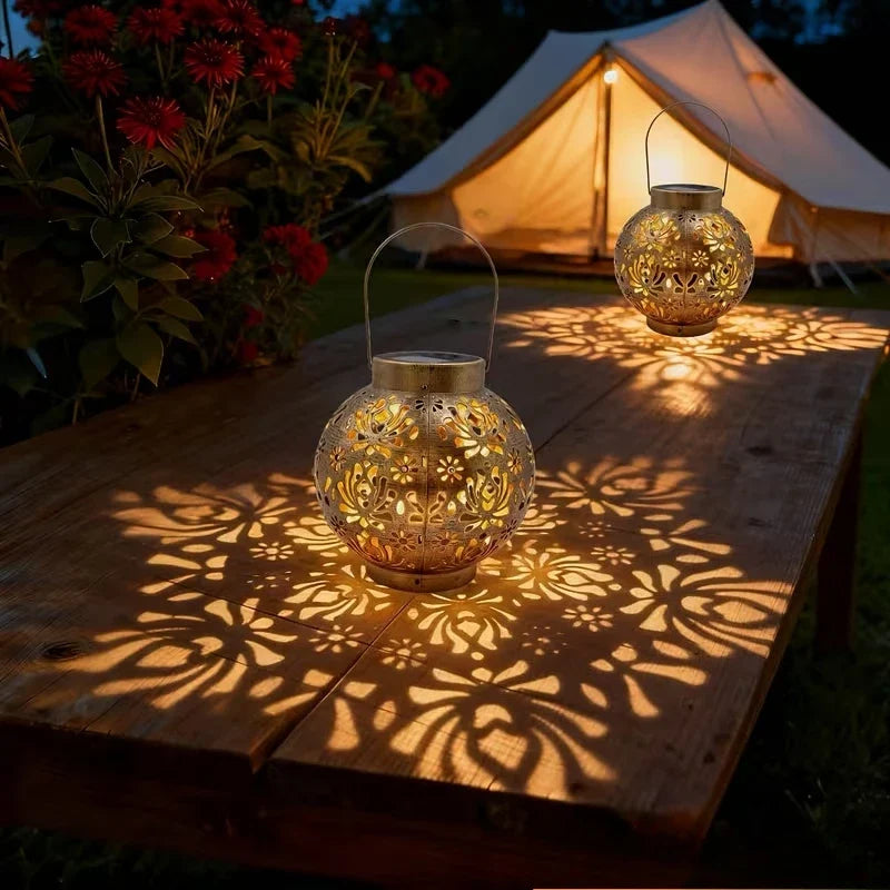 Bronze iron solar lantern with carved globe cutouts, warm light projection, hanging top