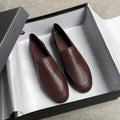 Dark brown slip-on leather loafers, flat design, round toe with stitched apron detail