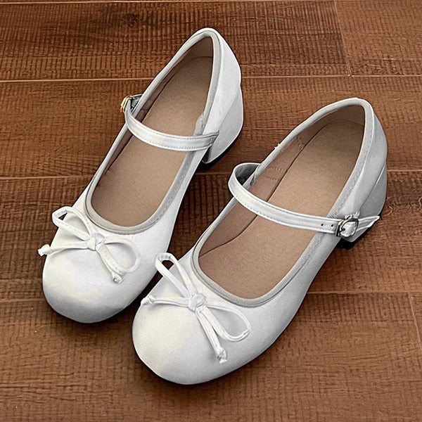 White Mary Jane ballet flats with ankle strap and small buckle