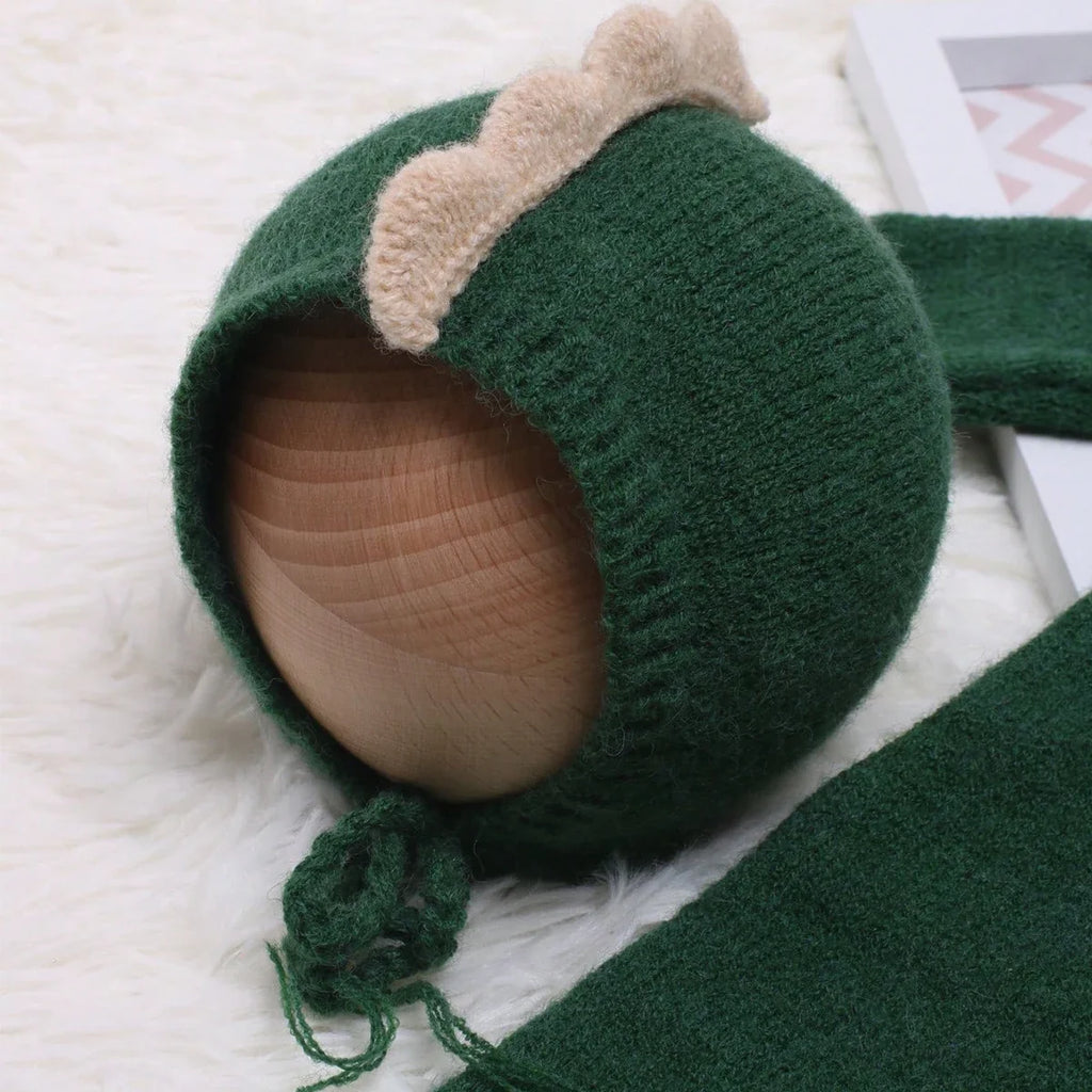 Green dinosaur hooded newborn jumpsuit with beige-lined hood