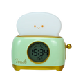 Light green toaster-shaped kids alarm clock night light with glowing face display