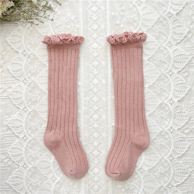 Knee-high ruffle socks with lace cuff, dusty pink pair laid flat