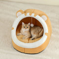 Yellow covered cat bed cave tent with cat inside, round white opening ring and pom-pom
