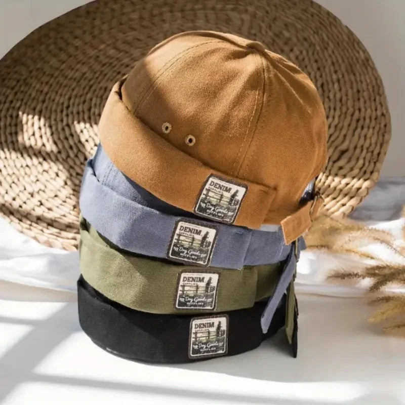 Brown canvas dome cap with adjustable strap and denim logo patch