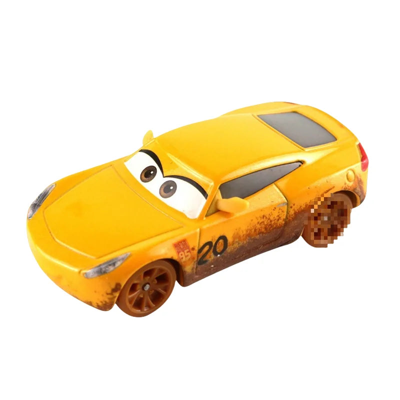 Yellow diecast race car model with scuffed paint and cartoon eyes