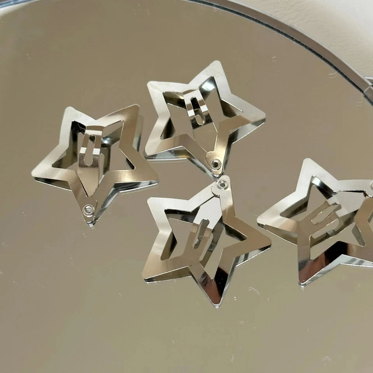 Silver star hairpins with metal snap clasps, shiny filigree star shape.