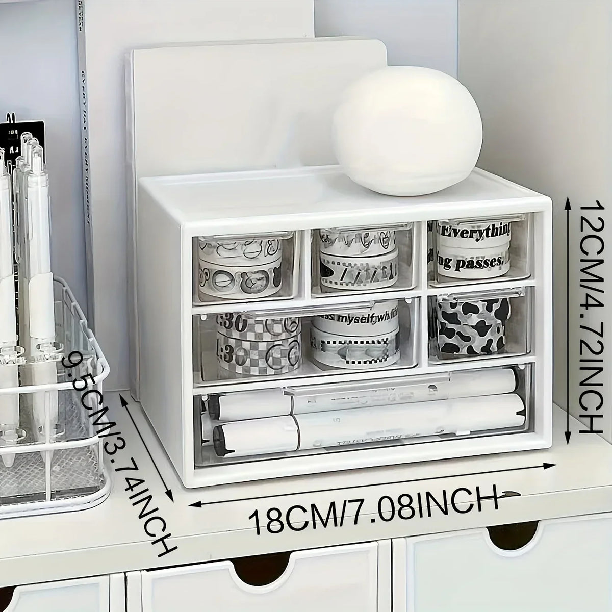 White desk organizer with lid open; visible compartments for rolls, clips, and small items