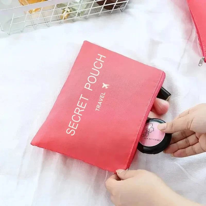 Coral pink waterproof packing pouch with zipper and “SECRET POUCH TRAVEL” text