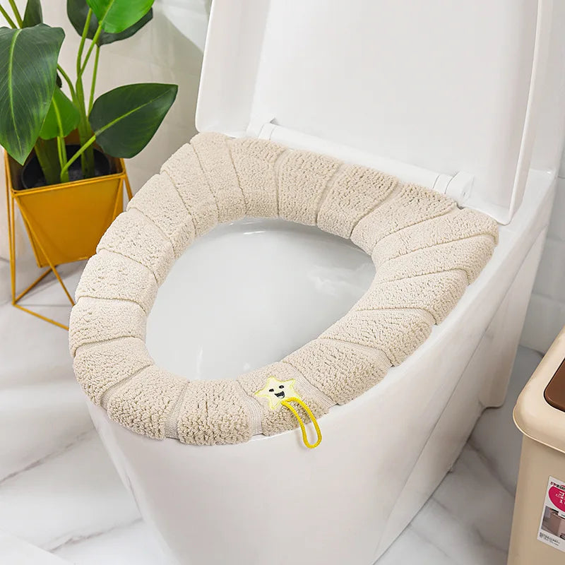 Beige plush toilet seat cover mat with handle, soft looped terry fabric.