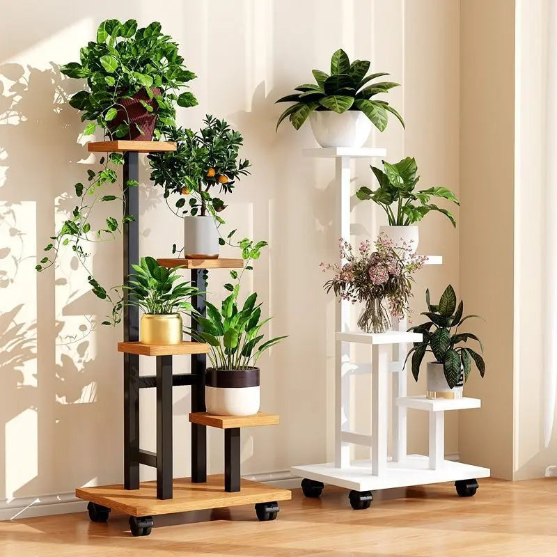 Rolling multi-tier plant stand with dark frame and light wood shelves, filled with potted plants.