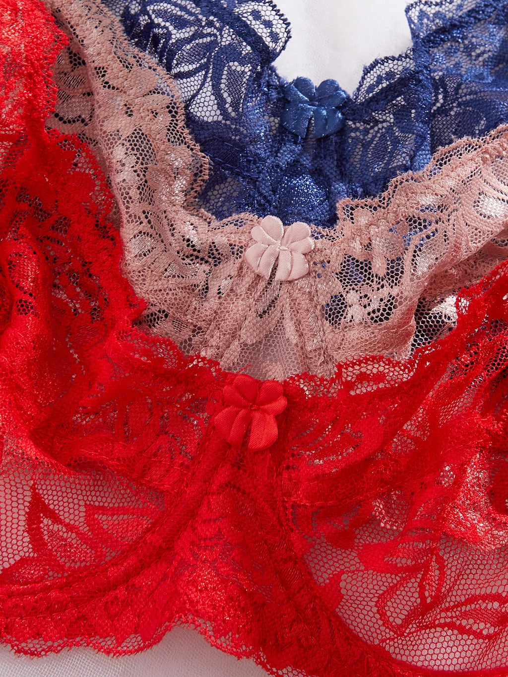 Floral lace underwire bra cups in red, navy, and blush tones with scalloped trim