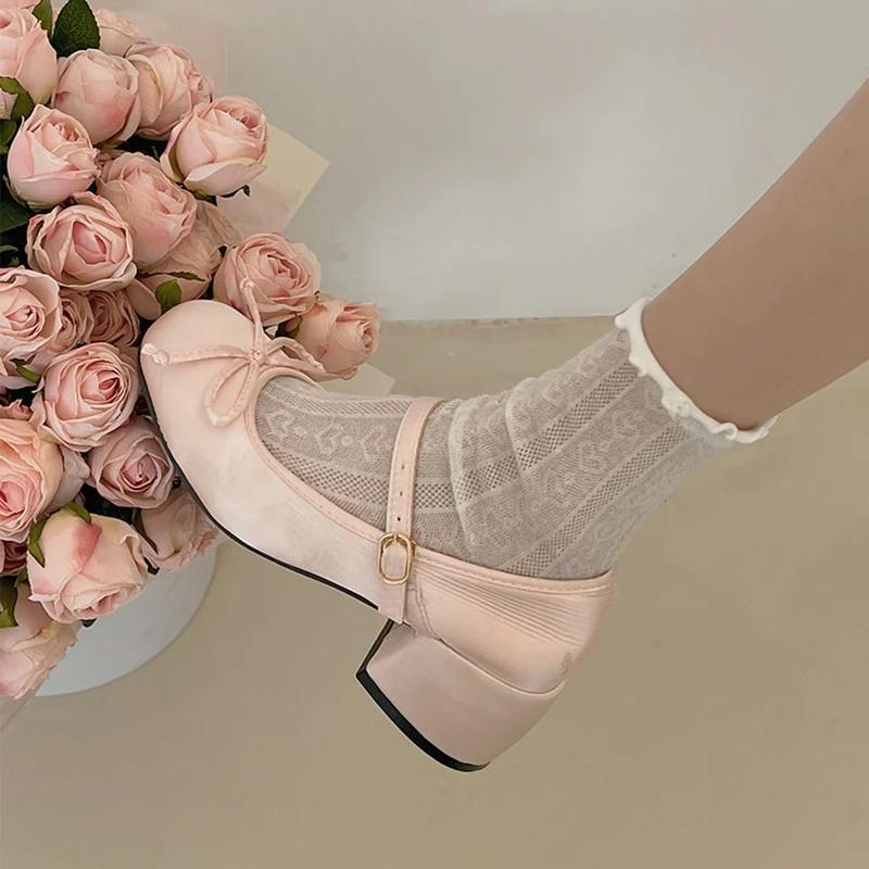 Blush pink Mary Jane ballet flats with ankle strap and bow, with sheer lace socks