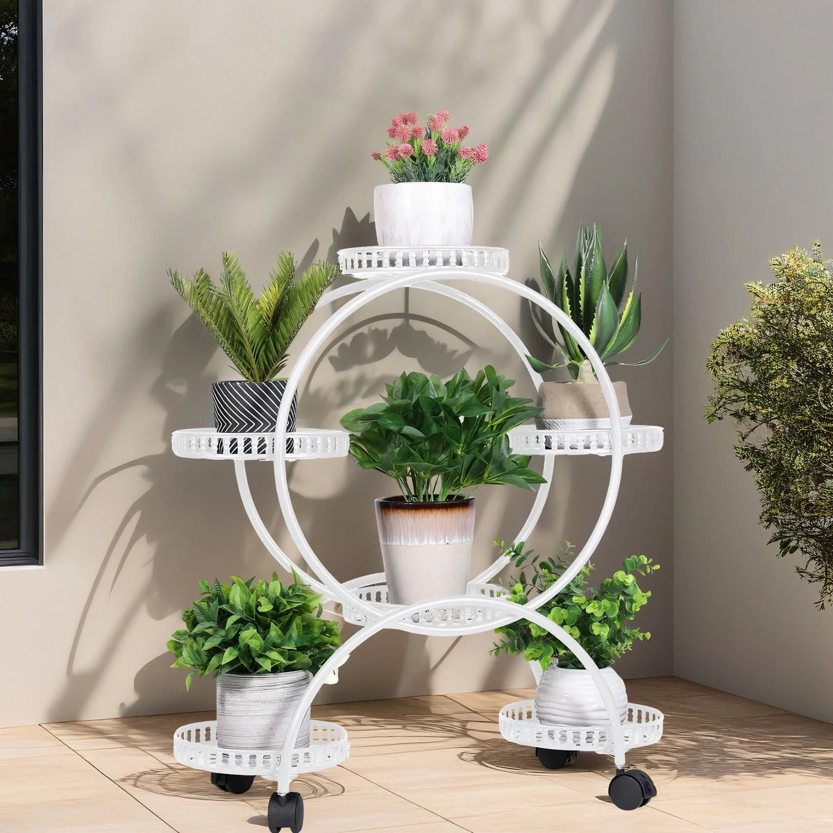 White metal rolling plant stand with four trays and lockable caster wheels