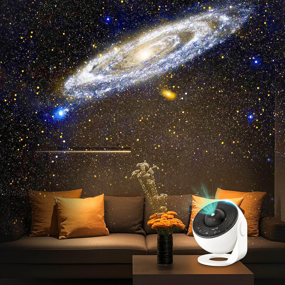Star projector placed on a table beside couch, projecting galaxy light patterns