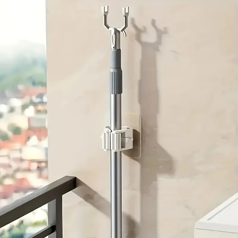 Single grey wall-mounted adhesive mop holder clip for broom handles
