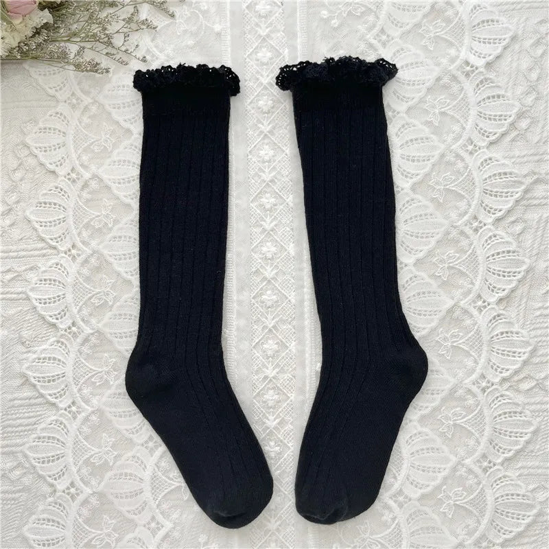 Black ribbed knee-high socks with ruffled cuff