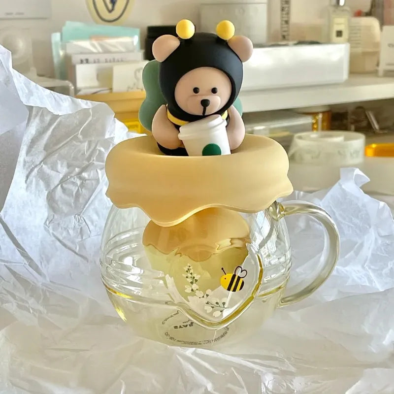 Glass tea infuser mug with bear-and-bee character lid and honey pot-style top