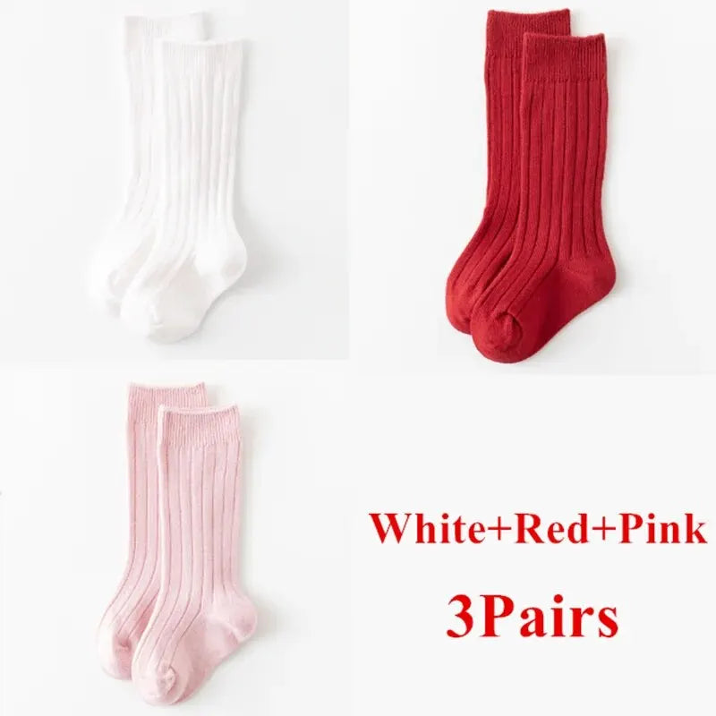 Kids knee-high striped socks in white, red, and pink, shown as three pairs.