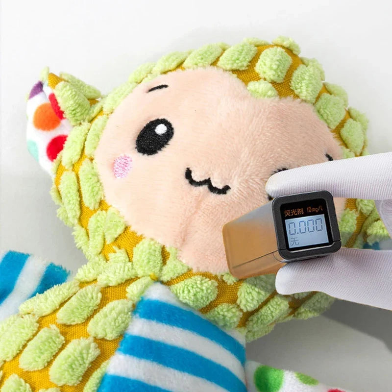 Pink and green cuddle bug plush dog toy with smile face and soft texture