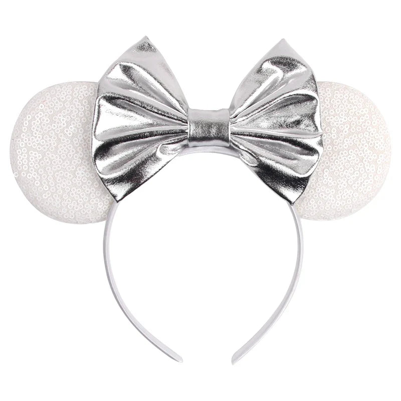 Silver metallic bow and glitter ears Mickey-style headband with curved band.