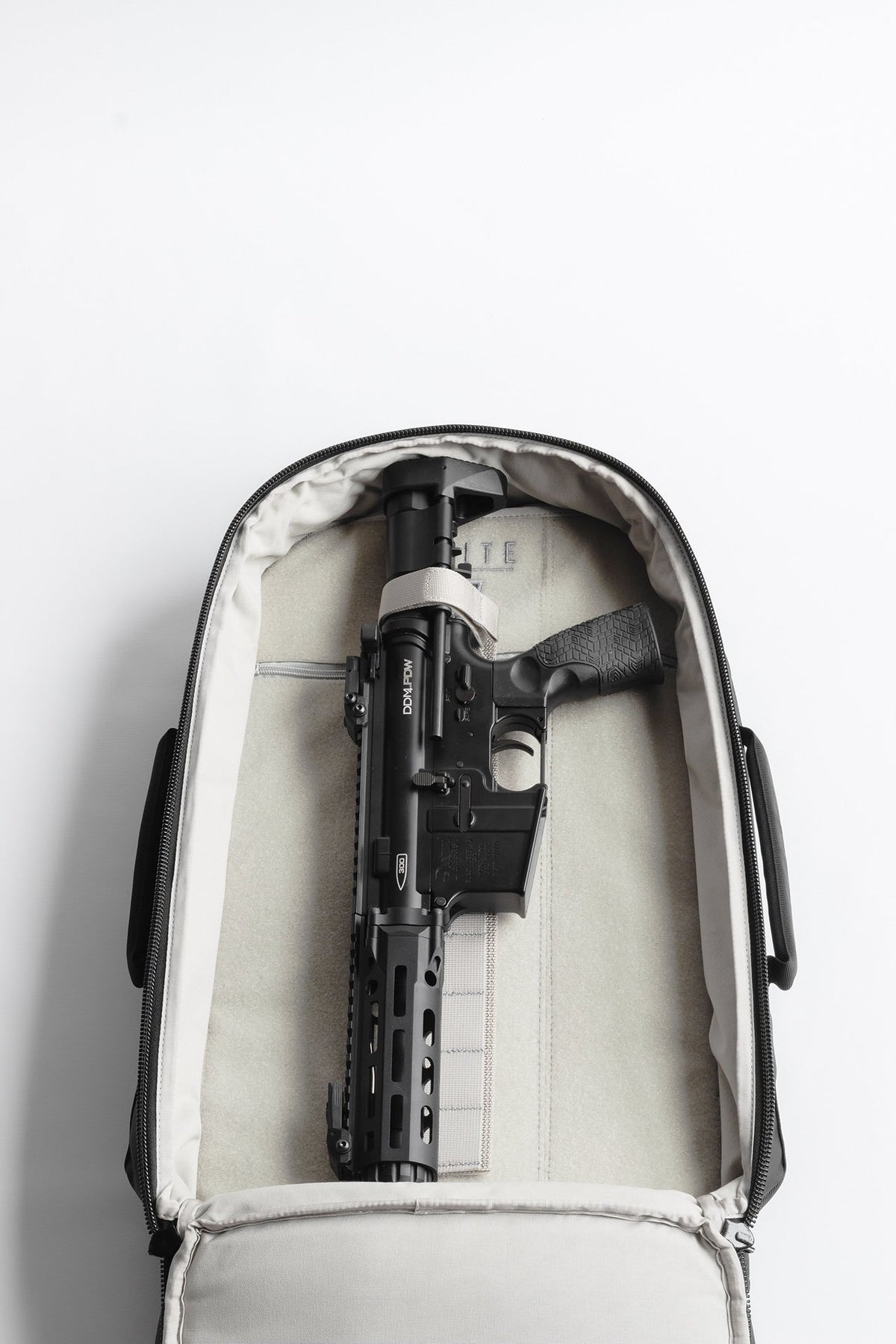 Tactical backpack with padded interior insert and black equipment, front view