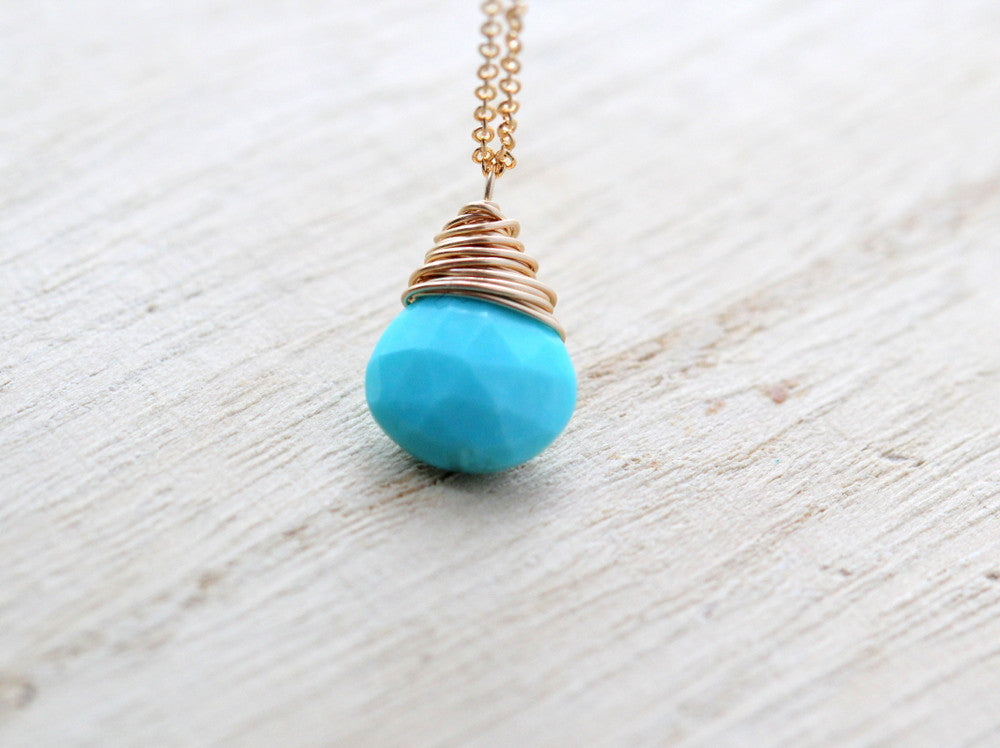 Turquoise teardrop pendant necklace with stacked wire coils and gold-tone chain