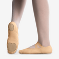 Light pink canvas ballet shoes with elastic strap and split sole, on dancer