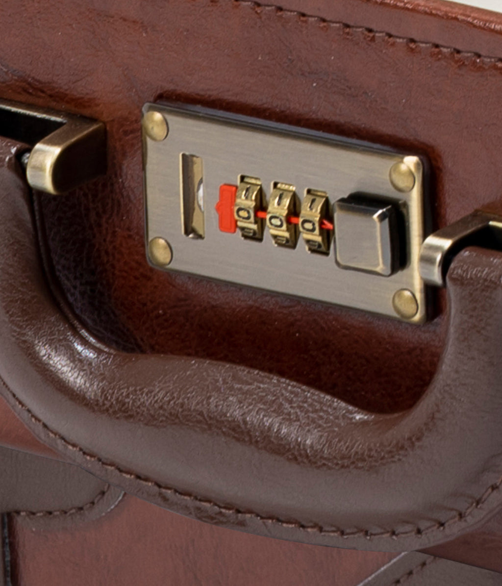 Caramel brown briefcase close-up of metal plate with combination lock