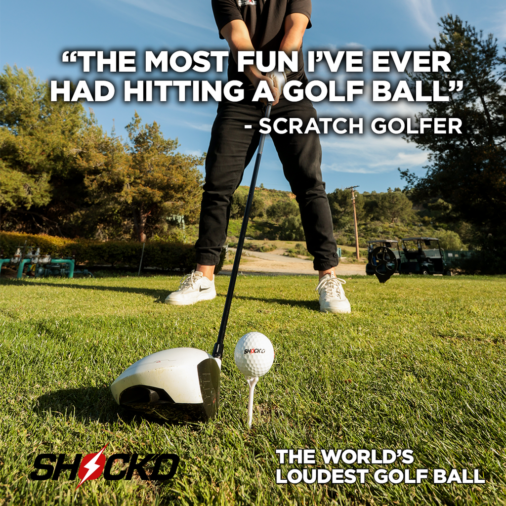 Golf ball on tee with golfer stance holding driver on outdoor green