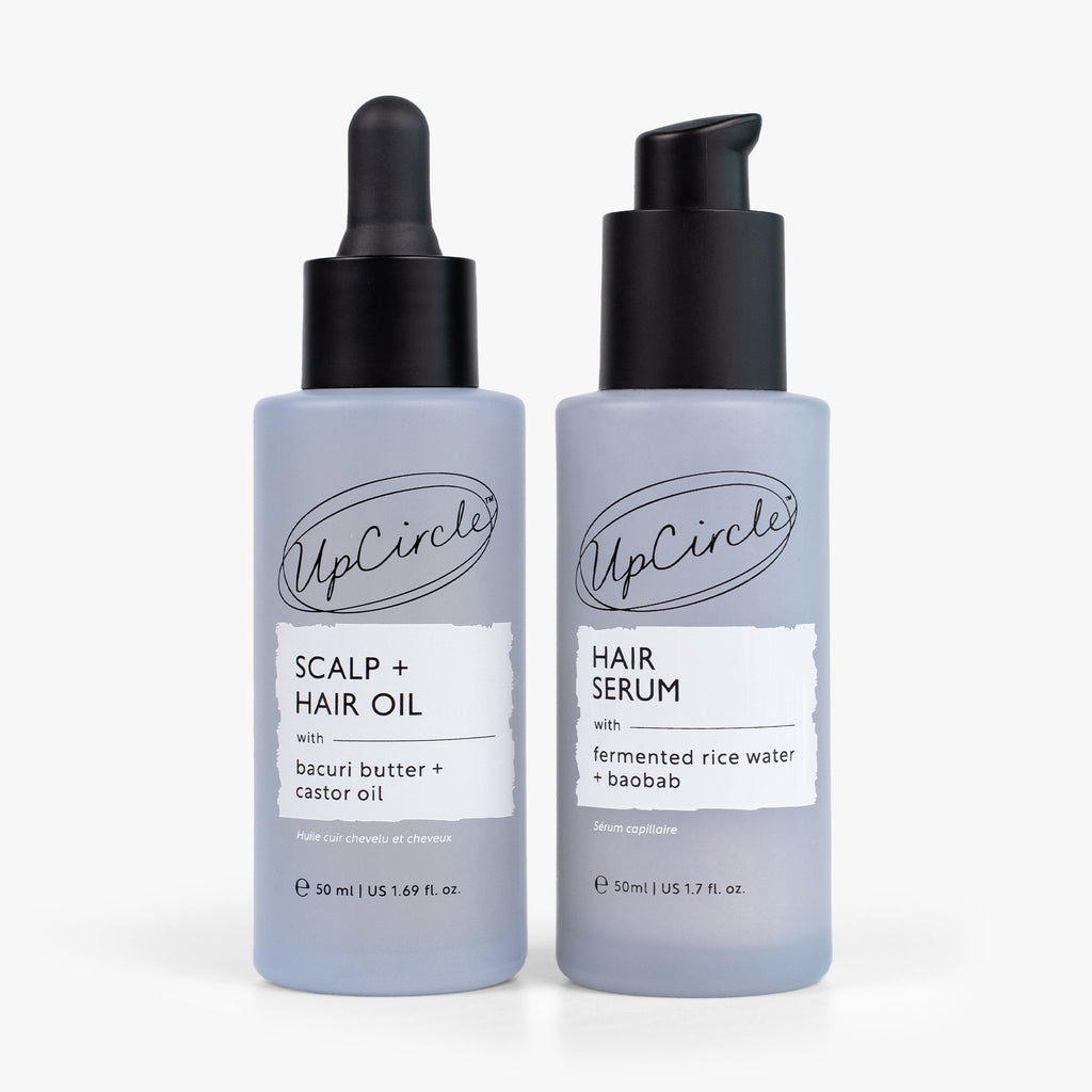 Hair oil and hair serum duo with light blue bottles and black pump caps