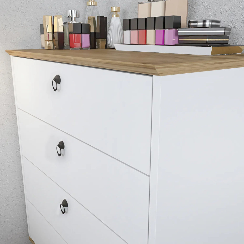 Modern dresser front with three drawers and black oval knobs, light wood top.