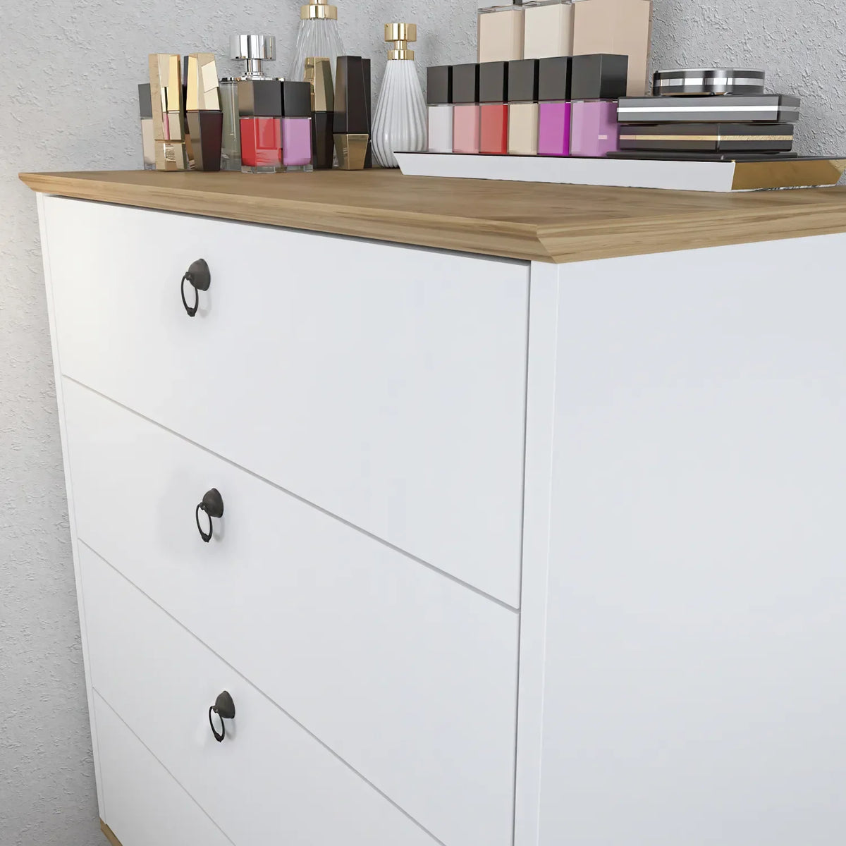 Modern dresser front with three drawers and black oval knobs, light wood top.