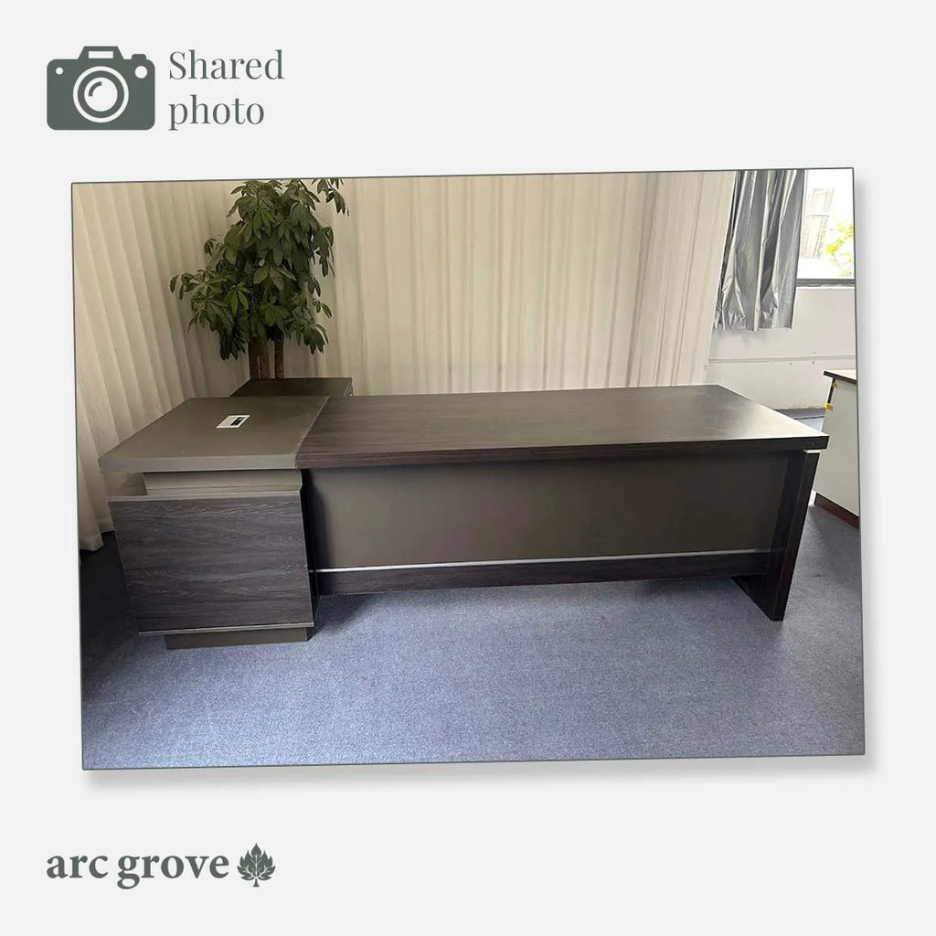 Dark oak L-shaped executive desk with gray top and side drawer return